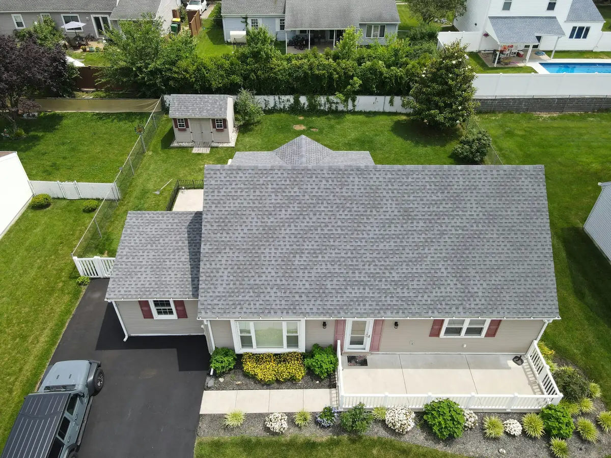 Aerial view of a suburban home with a new light grey roof