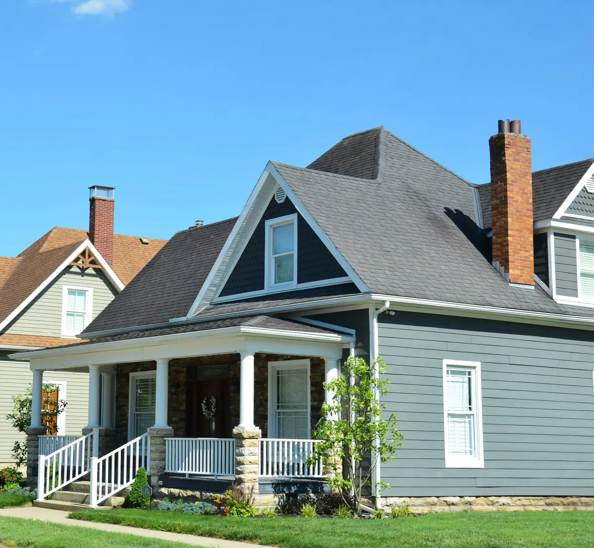 Blue clapboard home with a new grey roof and front porch