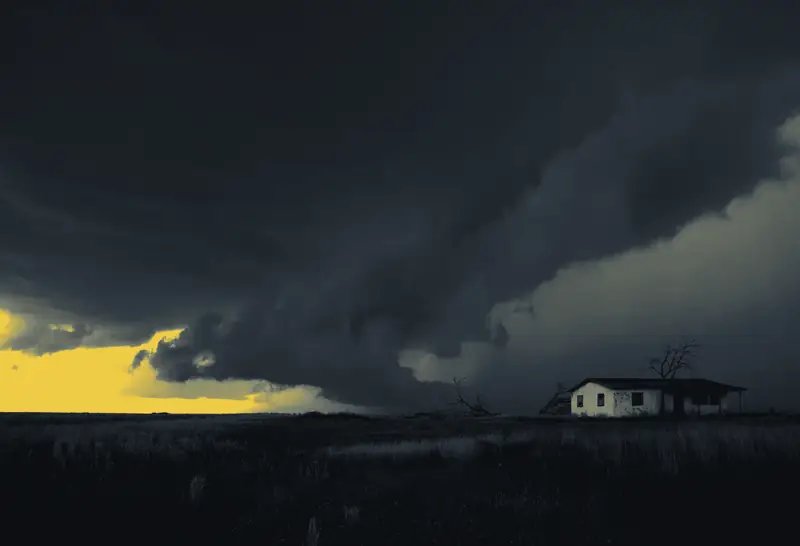 A dark storm front rolling over a lone farmhouse
